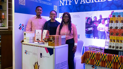 Three Ghanaian entrepreneurs stand at ITC booth at trade fair